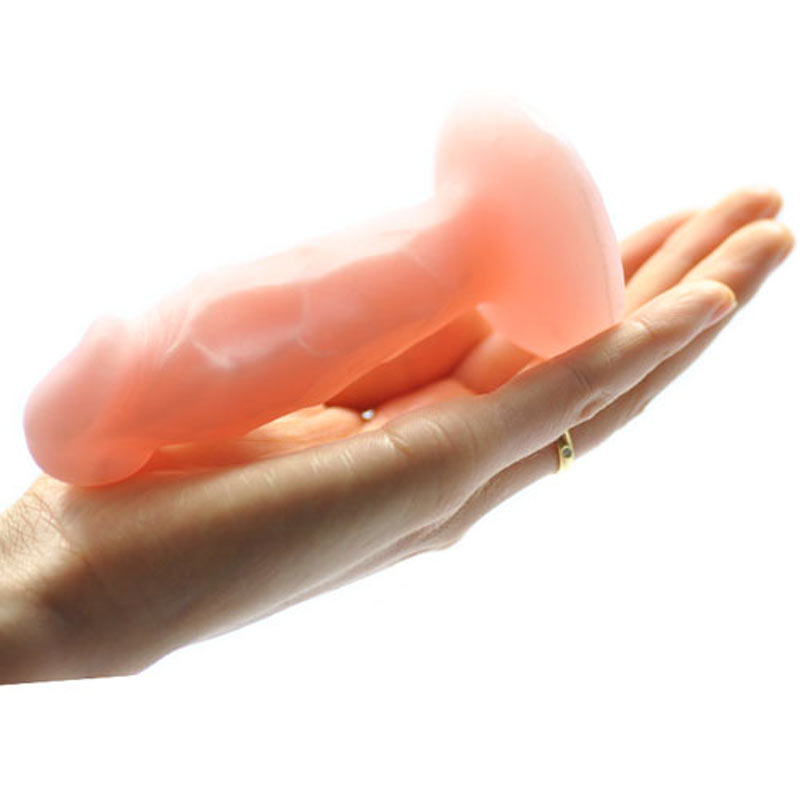A models hand holding the real cute dildo