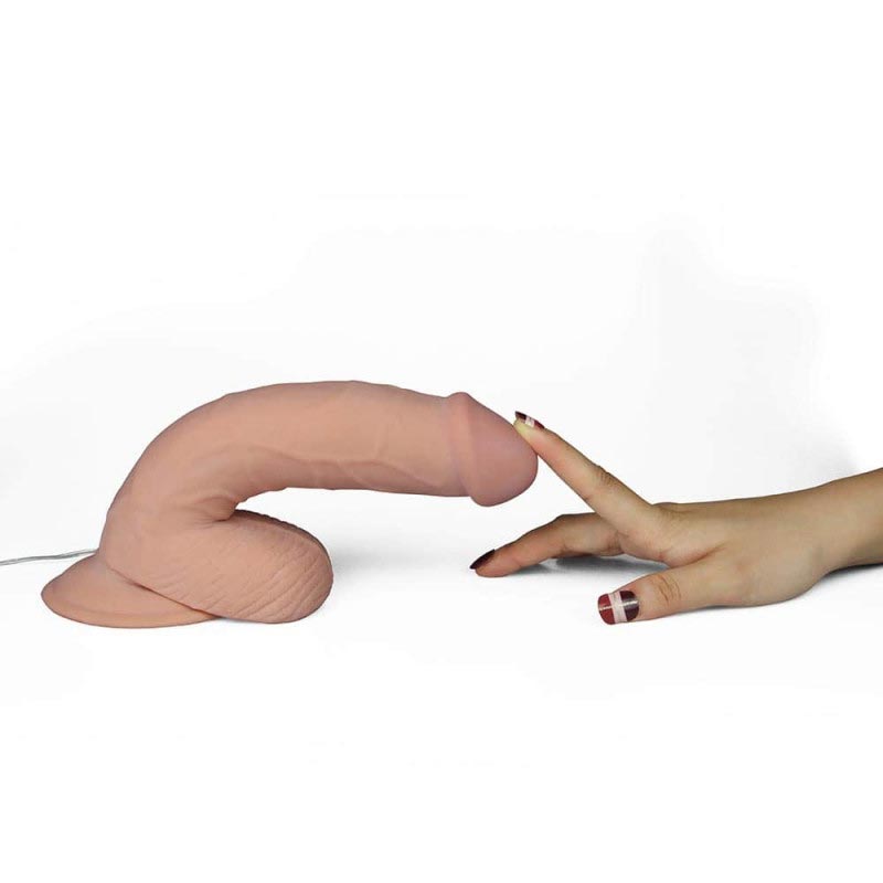 Love Toy The Ultra Soft Dude Realistic Dildo With Someone with their finger on the tip of the dildo pulling it down from a standing position