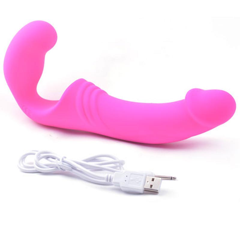 The pink strap-on with its charging cable