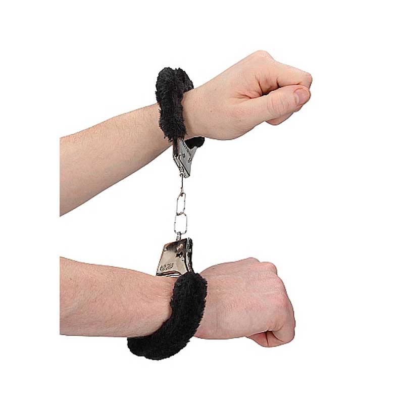 Two hands wearing the handcuffs