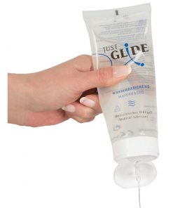 A women's hand squeezing out some lube