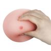 A person squeezing the The True Breast Flesh with a hand