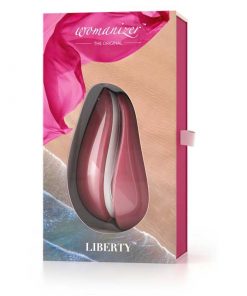 The Womanizer Liberty Clitoral Vibrator in its pink and red display box