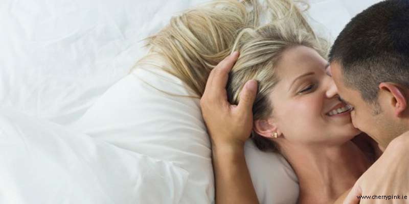 Tips to Get Your Sex Life Back on Track a couple in bed holding each other