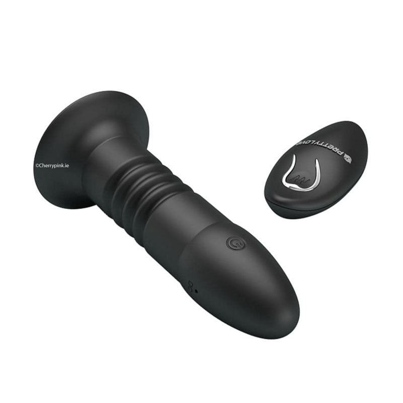 The front and tip of the anal sex toy with its remote control beside it