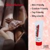 A couple holding hands with a tube of the hot lube standing to one side