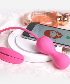 Pink egg , pink positioning anchor, mobile phone and perfume on a white plate.