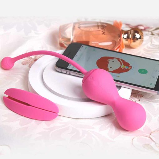 Pink egg , pink positioning anchor, mobile phone and perfume on a white plate.